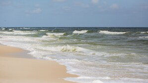 A beach with waves crashing onto the shore. - Sugar Sands RV Resort (Gulf Shores)