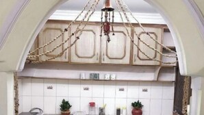 A kitchen with an arched ceiling, wooden cabinets, a marble countertop, and a hanging light fixture. - An independent floor, with one bedroom, kitchen, (Gurugram)