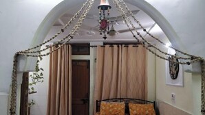 A bedroom with a bed, curtains, and a decorative canopy. - An independent floor, with one bedroom, kitchen, (Gurugram)