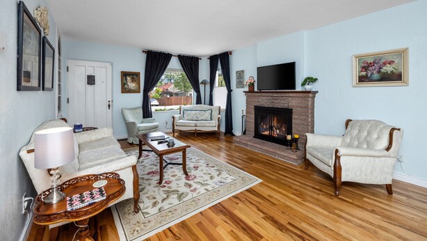 A living room with a fireplace, a sofa, a chair, and a coffee table. - Charming Home in Prescotts Historic District. Less than a mile from Whiskey Row. (Prescott)