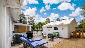 A backyard with a pool, lounge chairs, a grill, and a small shed. - Charming Home in Prescotts Historic District. Less than a mile from Whiskey Row. (Prescott)