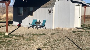 Un petit bâtiment d’un seul étage, doté d’un porche abrité, d’une enseigne accueillante et de deux chaises.