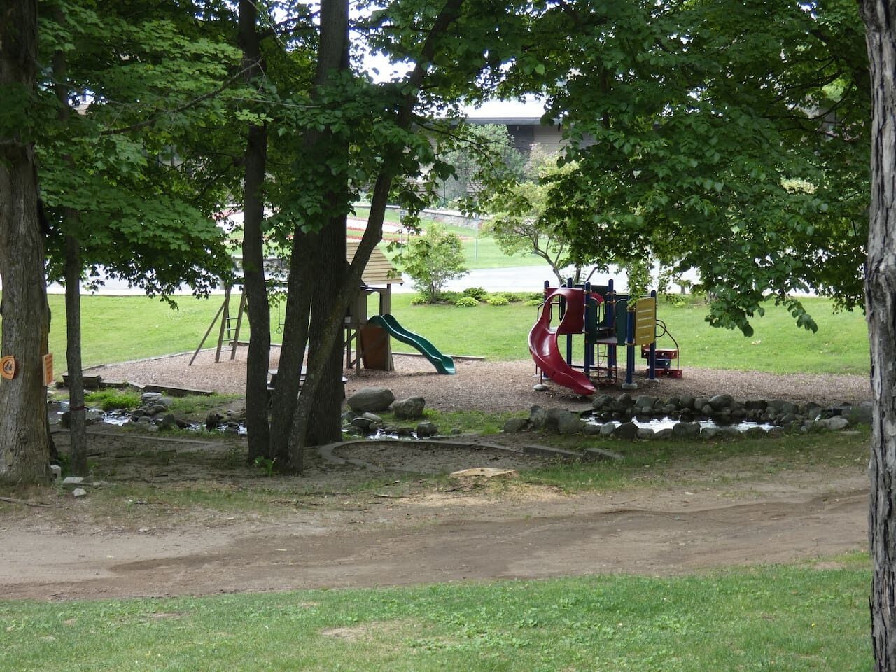 A playground with slides and a small water feature.
