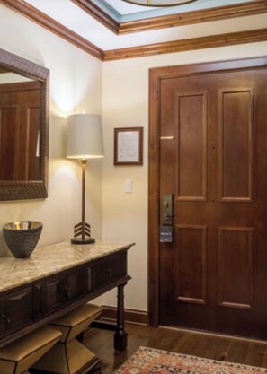 Enter a classic space with a traditional door, marble countertop, and elegant details.