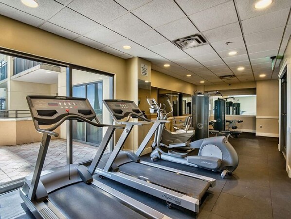 A gym with treadmills, elliptical machines, and weight equipment. - Origin 504 | Ocean view & Pool view | Sleeps 5 (Panama City Beach)