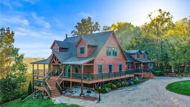 A large, multi-story house with a prominent porch and a gravel driveway. - Rustic/Modern Lodge near French Lick - Groups and Families (West Baden Springs)
