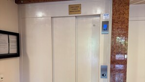 An elevator with a sign indicating it is for the disabled, a control panel with a number 4, and a plaque above the door.