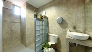 A bathroom with a shower, toilet, sink, and a glass partition. - Kerton Hostel (Koh Samui)