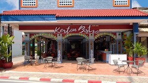A two-story building with a tiled roof and a sign reading "Kerton Bistro". - Kerton Hostel (Koh Samui)