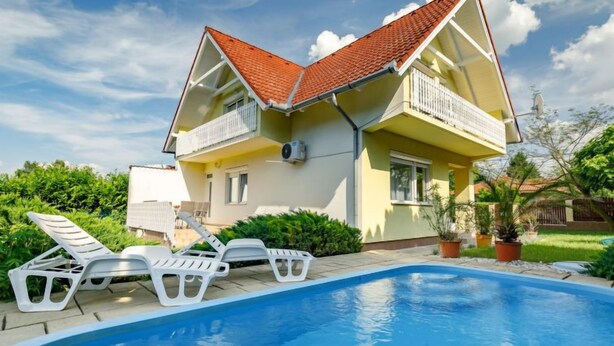 A two-story house with a swimming pool, a balcony, and a garden. - Vacation home Edina by Interhome (Balatonszarszo)