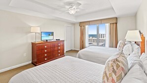 A hotel room with two beds, a ceiling fan, a TV, and a view of the city. - $150 activities - E-gift card when you book - Southern Ocean View with Gorgeous Sunsets | RP1906-2 (Myrtle Beach)