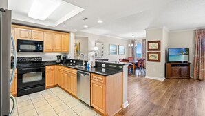 A modern kitchen with a central island, built-in appliances, and wooden cabinetry. - $150 activities - E-gift card when you book - Southern Ocean View with Gorgeous Sunsets | RP1906-2 (Myrtle Beach)