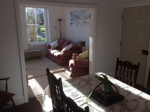 Relax in this inviting living area with a sofa, chair, and dining table.