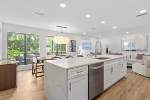 Enjoy meals in the spacious kitchen with a large island, dishwasher, and ample storage.
