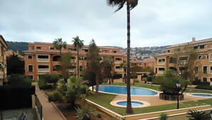 A residential complex with multiple buildings, a central swimming pool, and surrounding greenery. - Holiday Apartment - Javea Puerto - 2bedr 2 Bath (Javea)
