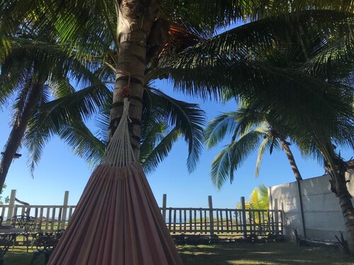 Is a Ocean front  family House, with coconut,  pool,  green garden