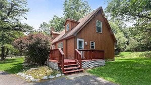 A wooden house with a porch and steps leading to the front door. - Beach, lake & pool within walking distance! Outdoor fire pit area, Game room (Albrightsville)
