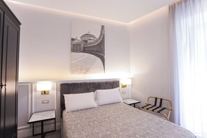 A hotel room with a bed, two bedside tables, a headboard, a wall-mounted artwork, and a window with curtains. - B&B L'Infinito 88 Charmant Rooms - Room 1 - King Superior with balcony (Napoli)