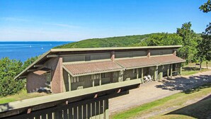 A building with a flat roof and a long, covered porch.