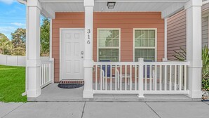 A house with a porch, a white door, and a mailbox. - “Mermaid’s Dream” Short Walk from the Waves & Pool (Myrtle Beach)