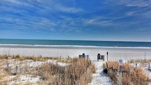 A beach path leading to the ocean with a clear sky. - “Mermaid’s Dream” Short Walk from the Waves & Pool (Myrtle Beach)