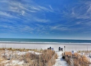 A beach path leading to the ocean with a clear sky. - “Mermaid’s Dream” Short Walk from the Waves & Pool (Myrtle Beach)