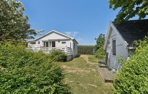 A white two-story house with a front deck and a small porch. - 3 bedroom nice home in Allinge (Allinge)