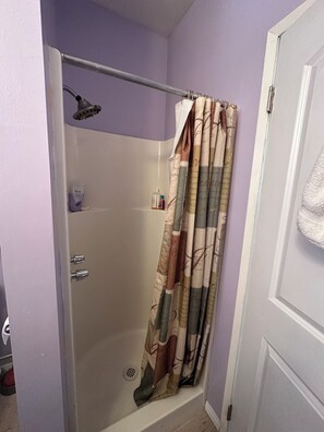 Bathtub, towels, soap, toilet paper