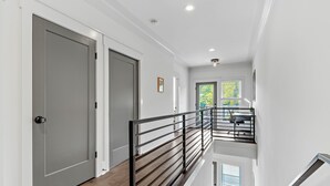 A modern interior with a staircase, white walls, and a wooden floor. - *SLEEPS 12* Keep the Secret *EAST NASH6* 4BR* 4BA* (Nashville)
