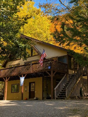 A two-story building with a wooden balcony and a staircase leading to the upper level. - Visit Willow’s Place! All season Pocono Retreat!  Kayaks, Canoes and Pedal Boat! (Lake Ariel)