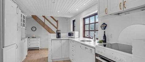 Fridge, stovetop, dishwasher, coffee/tea maker