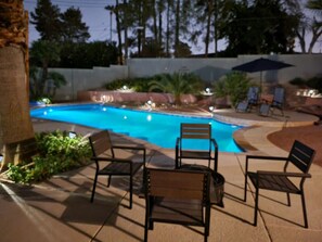 An outdoor swimming pool area with lounge chairs and a patio. - Spacious 4BR Near Strip with Private Pool, Free Parking (Las Vegas)