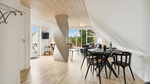 A spacious dining area with a high ceiling and natural light from large windows. - 5 bedroom nice home in Hadsund (Hadsund)