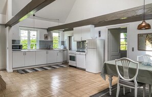Enjoy cooking in this well-equipped kitchen with an oven and refrigerator, and dine in the adjacent seating area.