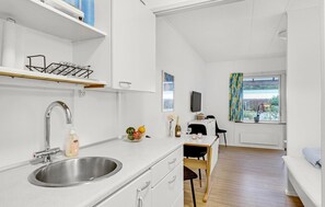 Fridge, stovetop, dishwasher, coffee/tea maker