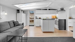 A modern kitchen with white cabinetry, a central island, and a built-in stove. - Awesome home in Sjølund with WiFi (Sjølund)