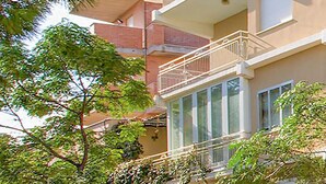 A multi-story building with a balcony on the second floor.