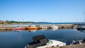 A marina with various boats docked, a calm sea, and a clear sky. - 1 bedroom awesome home in Svaneke (Svaneke)