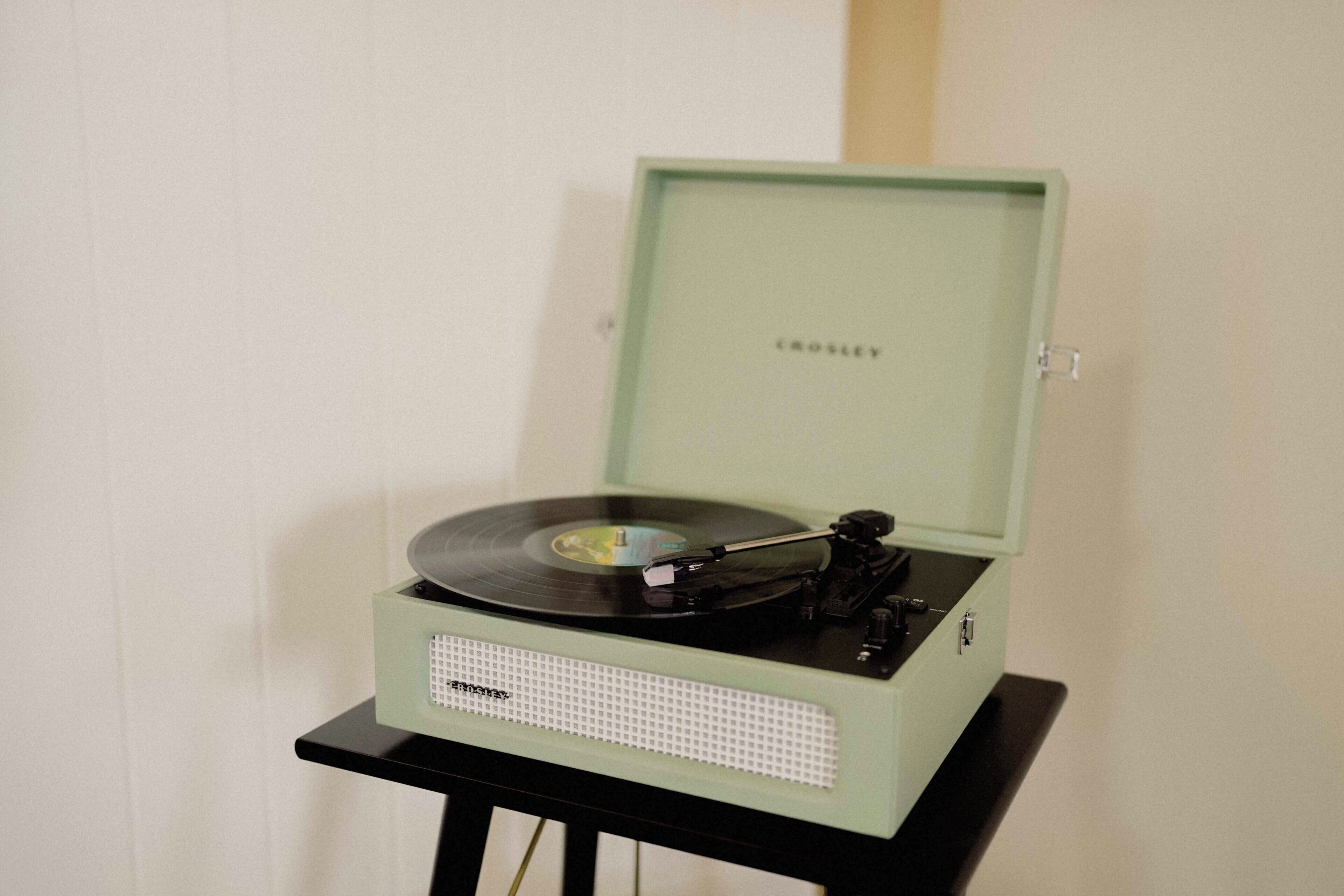 A Crosley turntable on a black stand.