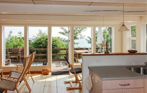 Enjoy a room with a view, featuring a dining area, kitchenette, and balcony with a railing.