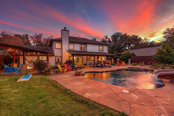 A two-story house with a backyard patio, a swimming pool, and a covered outdoor seating area. - North Austin Oasis near Domain  20 min to Downtown (Austin)