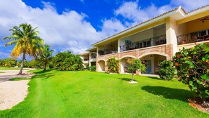 A two-story building with a flat roof and a balcony on the second floor. - Punta Cana Condo With Swimming Pool - Bavaro Condo Cocotal Sanitized (Punta Cana)