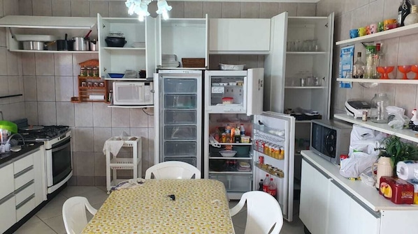 Fridge, microwave, stovetop, dining tables