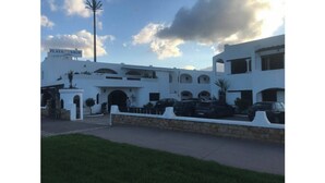 Un edificio blanco con varios arcos y un letrero que dice "PLAYA SMIR".