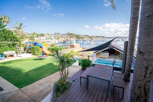 A deck with a view of a marina, a slide, and a swimming pool. -     Luxury Waterfront Penthouse in Cronulla (Burraneer)