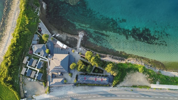 An aerial view of a coastal property with a road, buildings, and a beach. - Santana Resort Hotel (Trabzon)