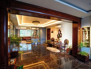 A spacious lobby with a chandelier, a reception desk, and a seating area with a sofa and chairs. - WelcomHeritage Elysium Resort & Spa (Shimla)