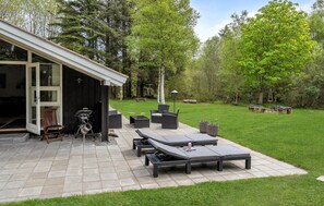 A patio area with outdoor furniture, a barbecue grill, and a covered seating area. - 4 bedroom gorgeous home in ålbæk (Ålbæk)