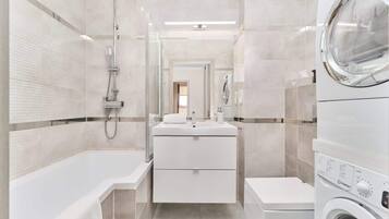 Bathtub, hair dryer, towels, shampoo