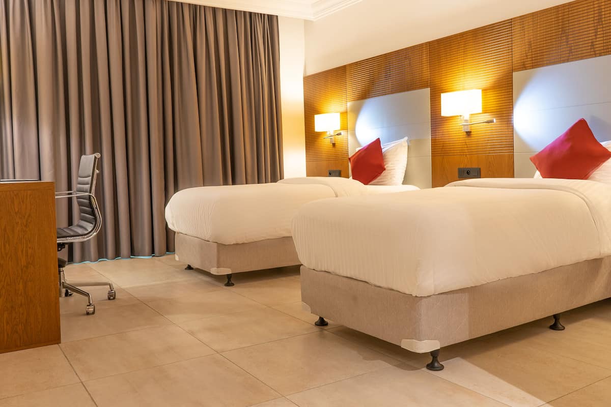 executive twin room, multiple beds, non smoking, pool view | 1 bedroom, minibar, in-room safe, individually furnished